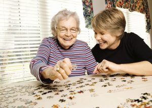elderly women doing puzzle